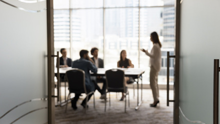 A slightly blurred image of a board meeting taking place