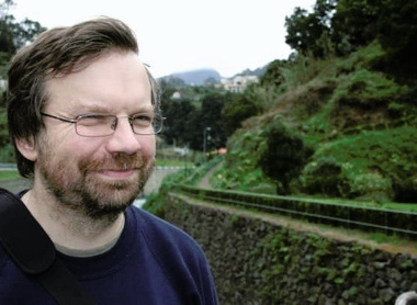 Nigel Brown smiling and looking away from the camera