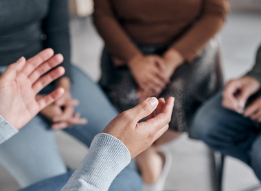 Group of people sitting in circle talking