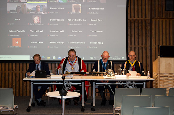 Honorary officers at the 2021 AGM with screen of virtual attendees behind