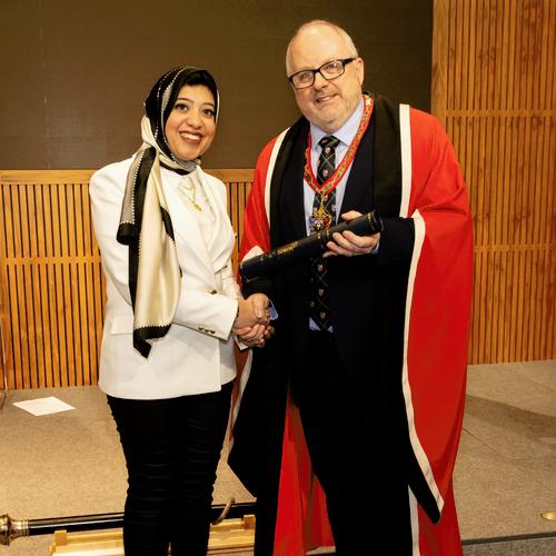 Dr Nesrin Tolba receives her award from Dr Bernie Croal at the New Fellows Ceremony
