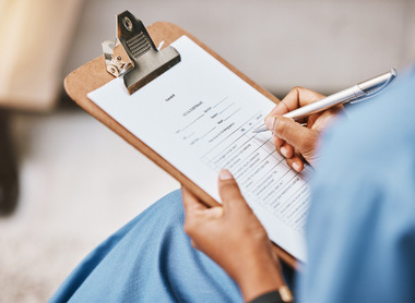 Healthcare professional filling out a medical history checklist