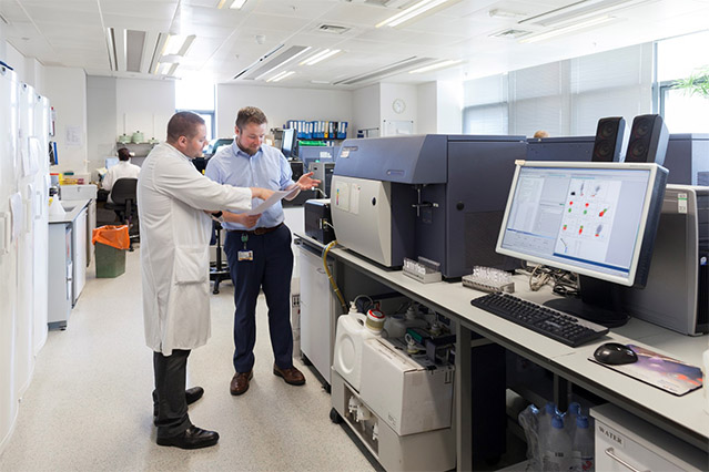 Dr Tom Butler and Dr Tim Farren looking at results from a machine in a lab