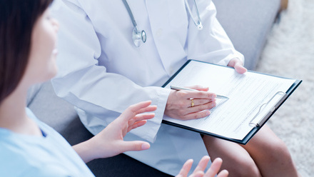 Doctor wearing a stethoscope holding a clipboard