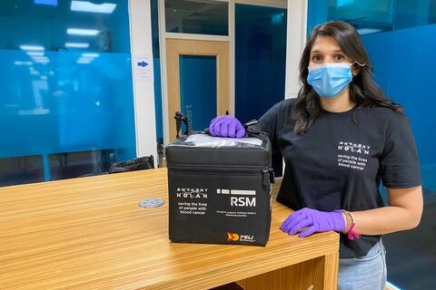 An Anthony Nolan worker showing a sample storage container