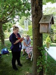 Nurses treat elderly patient at a Hospital at Home clinic 