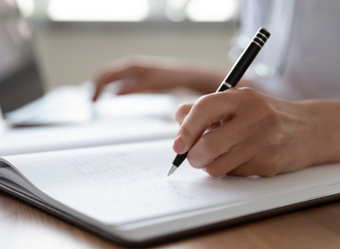 Person making notes in a notepad