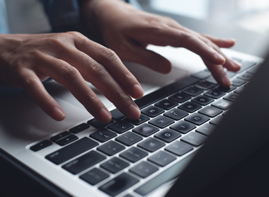 Person typing on laptop