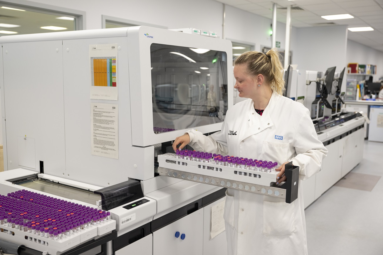 Putting samples in a machine in a haematology lab