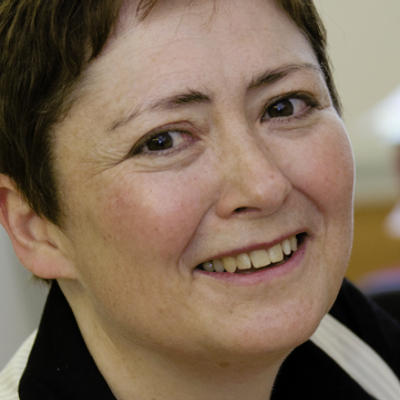 Dr Sue Avery smiling at the camera in an office