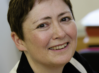 Dr Sue Avery smiling at the camera in an office