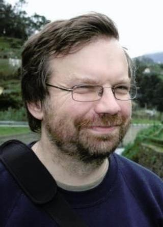 Nigel Brown smiling and looking away from the camera