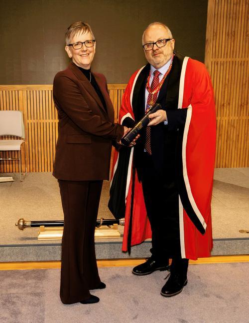 Dr Maria Brereton receives her award from Dr Bernie Croal at the New Fellows Ceremony