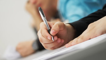 A person marking an exam paper