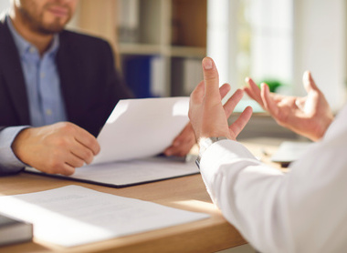 Discussion at desk between 2 people