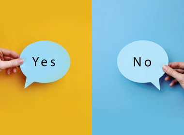 Cut outs of Yes and No speech bubbles on yellow and blue backgrounds