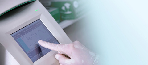 Person using the screen on a real-time PCR machine