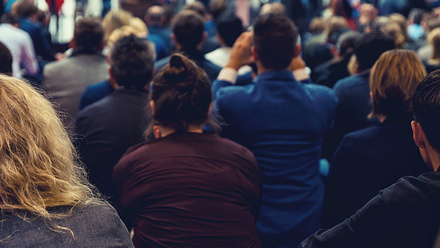 Audience listening to a speaker at an event