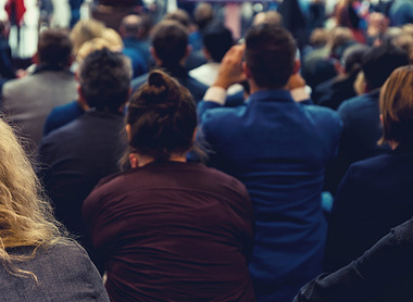 Audience listening to a speaker at an event