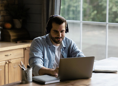 Person attending online event  on their laptop at home