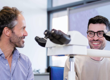 Students looking into microscope at a London Hospital