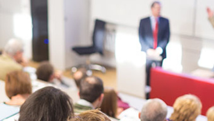 Attendees listening to a lecture in a lecture theatre_cropped