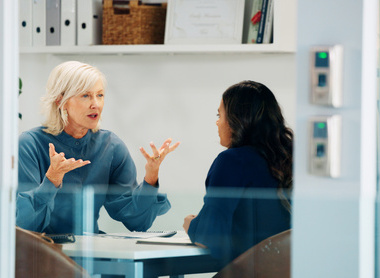 Two people having a discussion at a desk