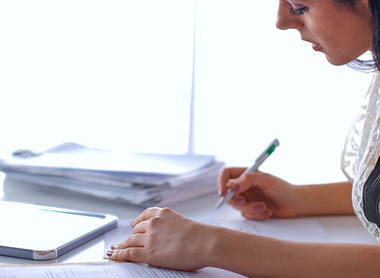 Person writing an evaluation report