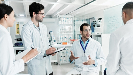 Group of scientists working together in a lab - shutterstock_2294225219.jpg