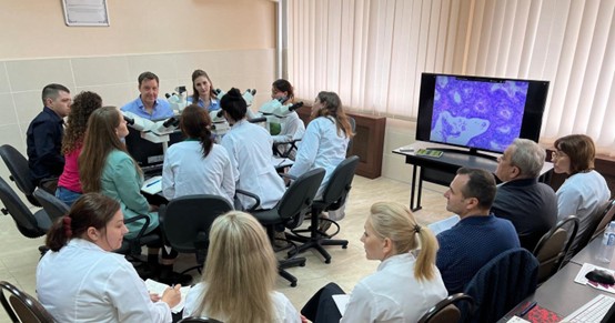 Dr Michael Coutts  teaching Moldovan pathologists in a workshop on cervical cancer screening.
