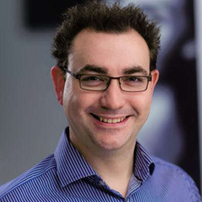 Dr Joel Newman smiling at the camera