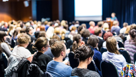Audience listening at a conference