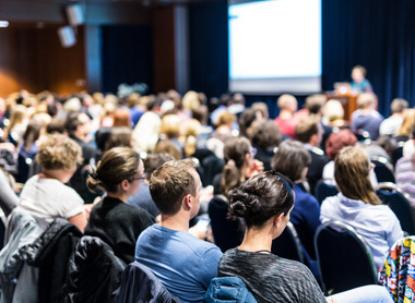 Audience listening at a conference