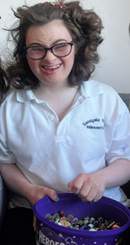 Lucy smiles after an easy experience using the Touch Activated Phlebotomy (TAP) device