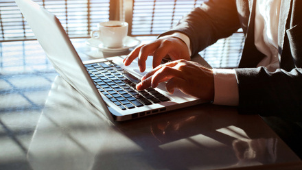 Person typing on laptop at a desk