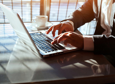 Person typing on laptop at a desk