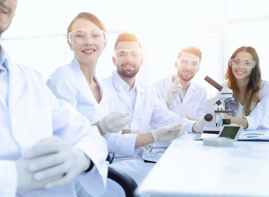 Group of scientist in front of microscope