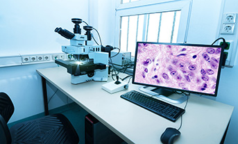 A digital pathology set up with microscope and screen