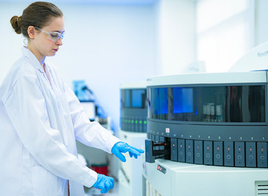 A clinical scientist initiates a batch test on a high-throughput immunoassay analyzer