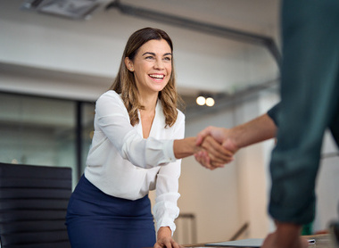 Person shaking someone's hand at an interview