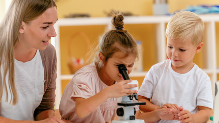 Young children looking down microscope.jpg