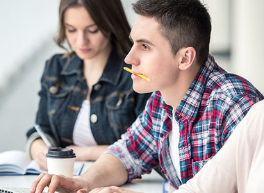 Students at a lecture writing notes