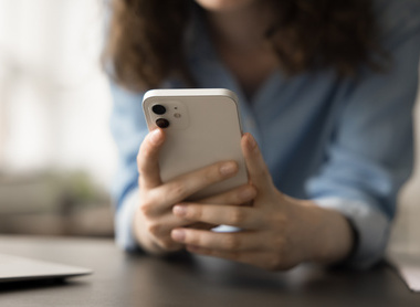 Person holding phone and reading