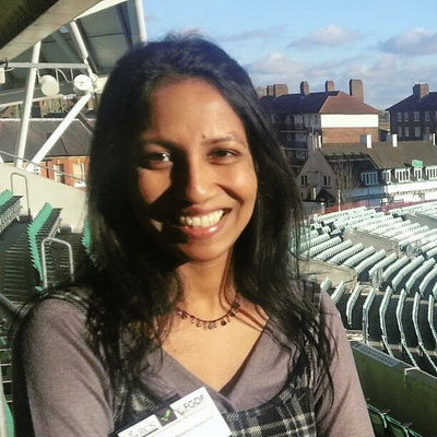 Dr Eranga Nissanka-Jayasuriya smiling at a sports stadium