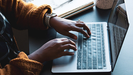 Doctor typing notes at a laptop