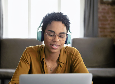 Person with headphones on laptop