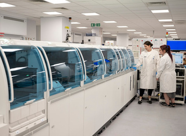 Two people working in a clinical chemistry laboratory