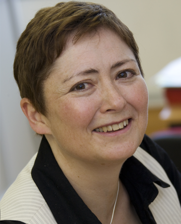 Dr Sue Avery smiling at the camera in an office