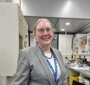 Dr Kimberly Gilmour smiling at the camera in a laboratory